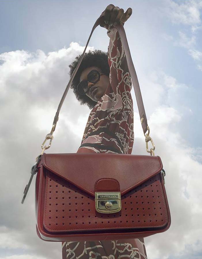Longchamp woman holding out bag
